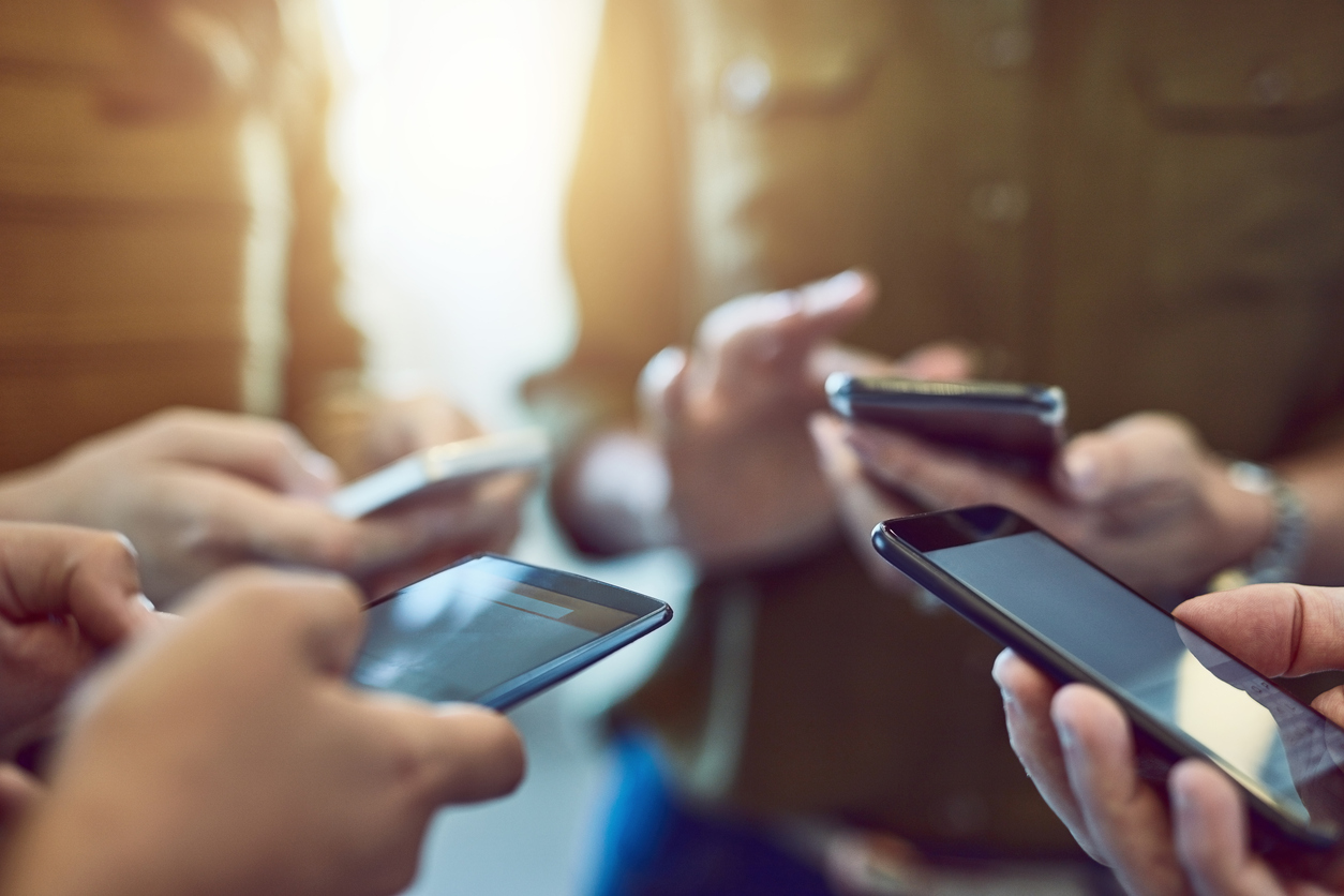 Group of people using phones to access multiple channels