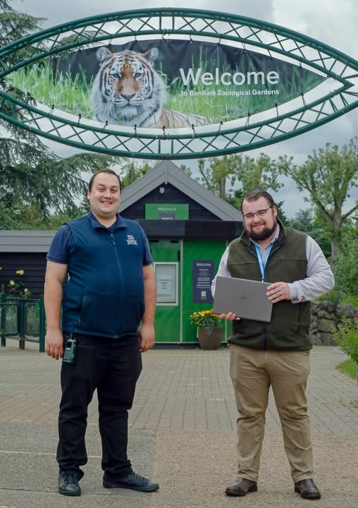 Dieter handing a laptop to zsea