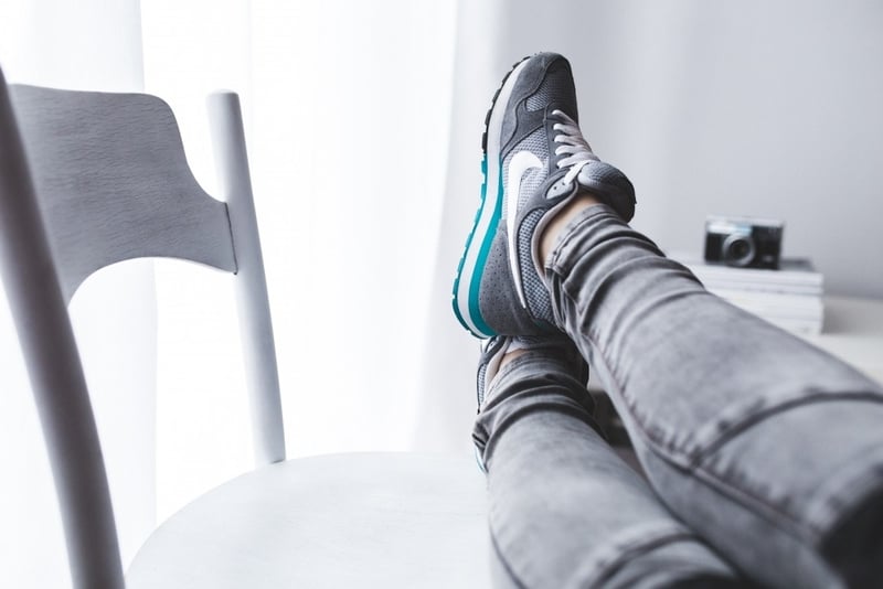 Someone putting their feet up to show convenience from mobile apps